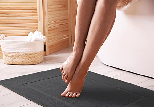 Two grey cotton bath mats stacked