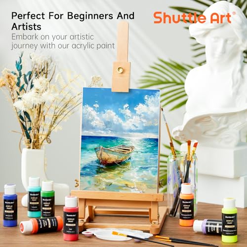 Hand holding a bottle of Shuttle Art acrylic paint