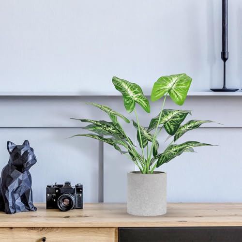 Two artificial plants with green leaves
