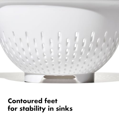 White OXO strainer inside a kitchen sink