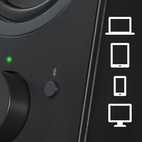 Black Logitech Z207 speakers on desk