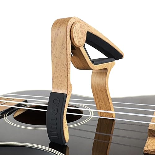 WINGO capo attached to acoustic guitar neck