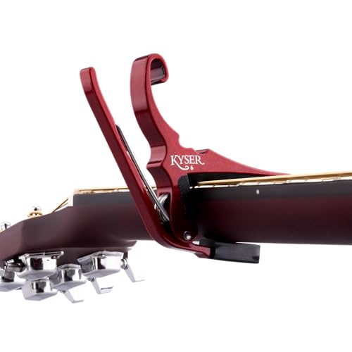 Ruby Red Kyser capo clamped on acoustic guitar