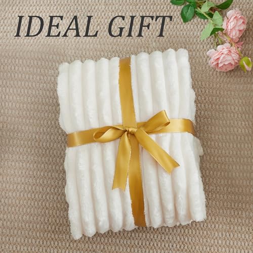 Cream fleece blanket draped over a modern couch
