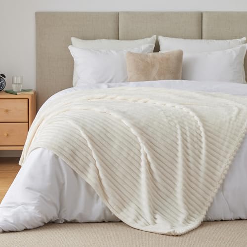 Cozy lifestyle view of the 50x60 cream throw