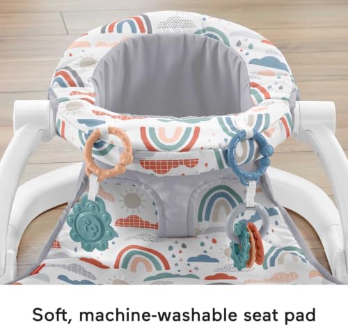 Baby sitting in Rainbow Showers floor seat