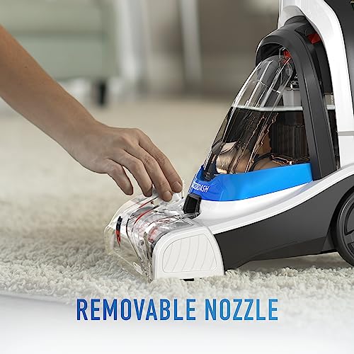 Blue carpet cleaner machine on rug