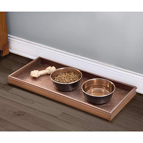 Copper boot tray used under a potted plant