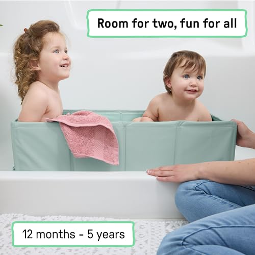 Toddler sitting inside the Ingenuity Tuckaway Folding Tub