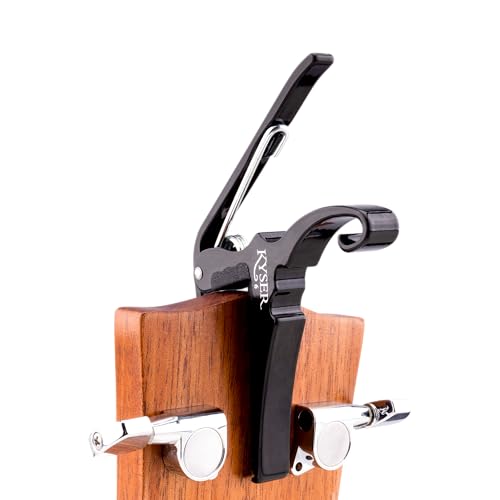 Close up of Kyser guitar capo clamping on fretboard
