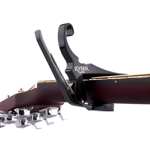 Kyser guitar capo parked on acoustic headstock