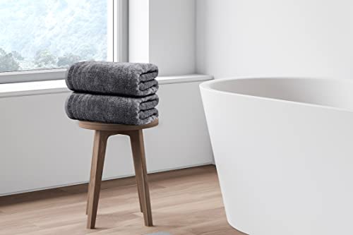 Stack of four dark grey bath towels