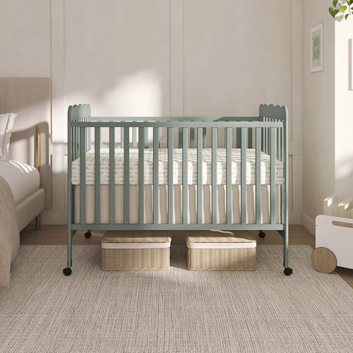 Side profile of Dream On Me Carson crib with wheels