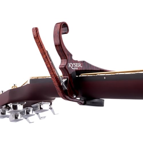 Kyser Quick-Change capo attached to acoustic guitar fretboard