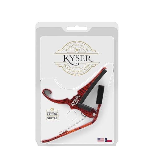 Kyser capo stored on the headstock of an acoustic guitar