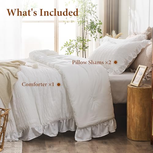 Full view of queen bed with ruffled comforter
