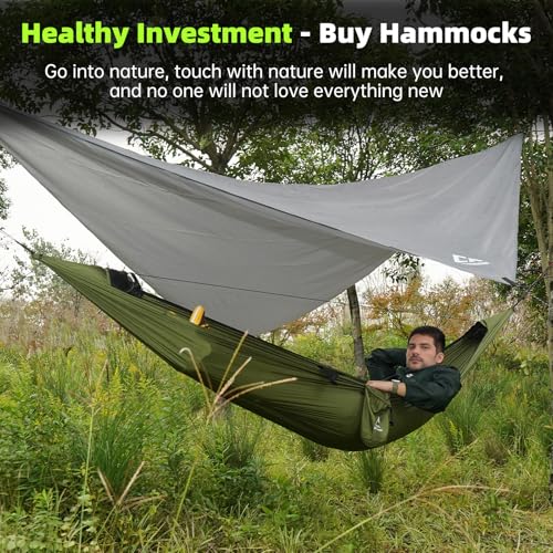 Green camping hammock setup with rain fly
