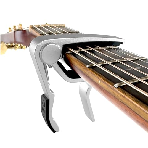 Silver capo clamped on guitar