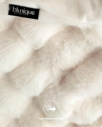 Cream white blanket folded on a bed