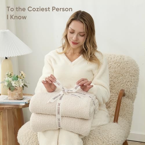 Snuggle Sac 50x60 throw displayed on a bed