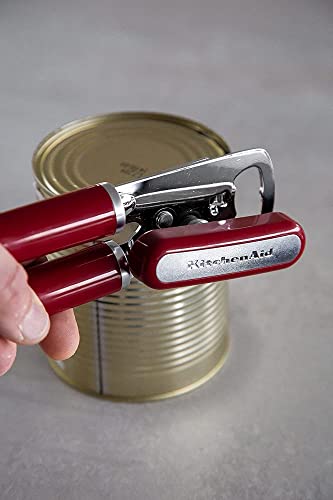 KitchenAid Empire Red can opener being used on a metal can